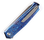 Kansept Integra Framelock Timascus with blue patterned handle and satin blade, angled view.